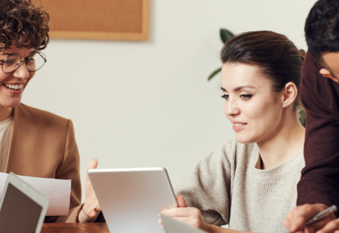 Group of individuals working together around a table.